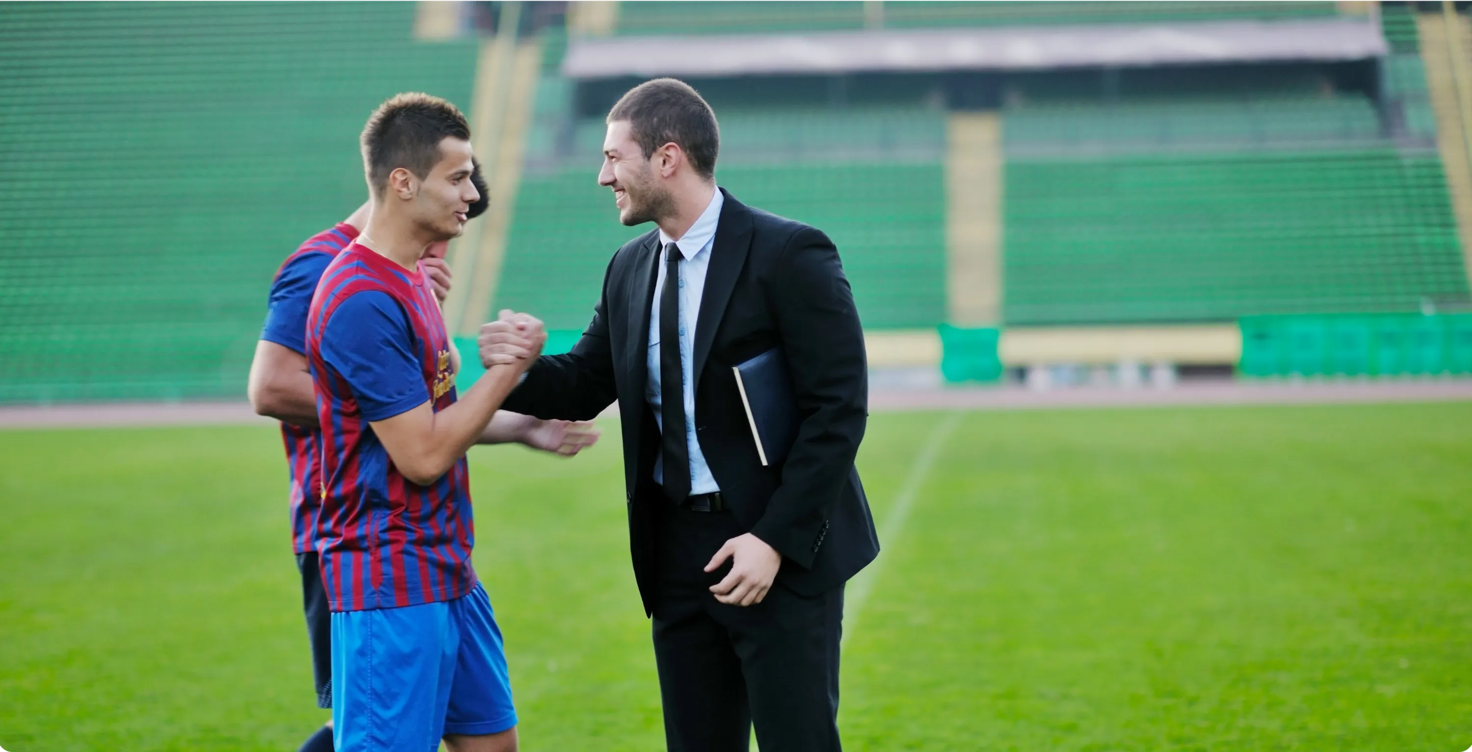 Manager discussing report with player